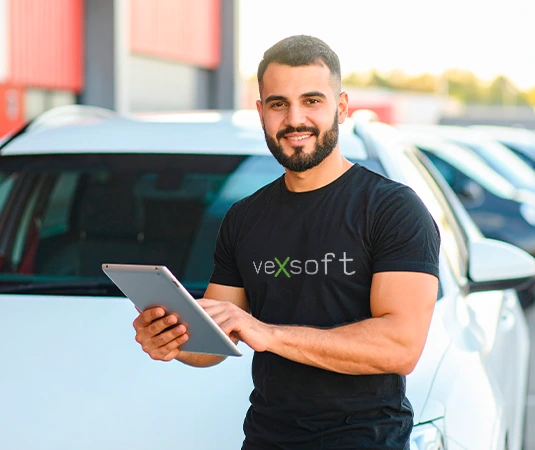 Homem com uniforme VEXSOFT realizando vistoria cautelar com tablet e carro ao fundo
